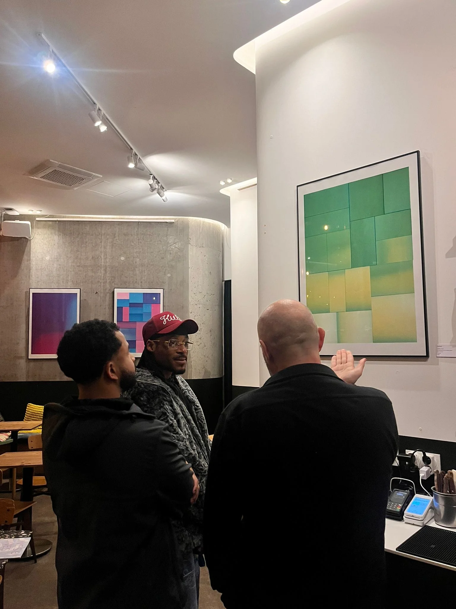 Vernissage — people in front of the works