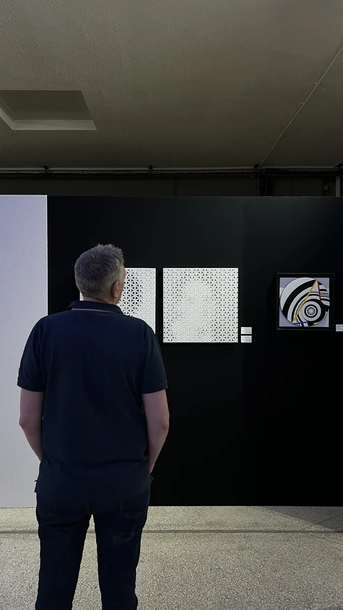 A visitor in front of Y¹ and Y²