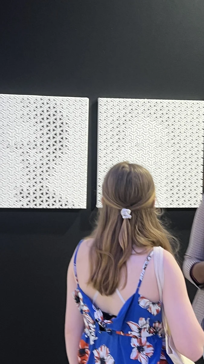 A visitor in front of Y¹ and Y²